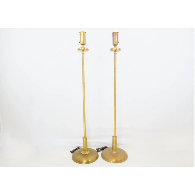 A fine pair of 1940's Art Deco torchères / floor lamps. Features a quarter dome rounded base. Solid brass with rings and...