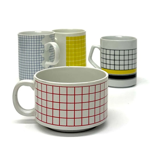 Vintage Grid Mugs, group of 4 An eclectic set of vintage ceramic mugs with assorted multicolored grid patterns. The set...