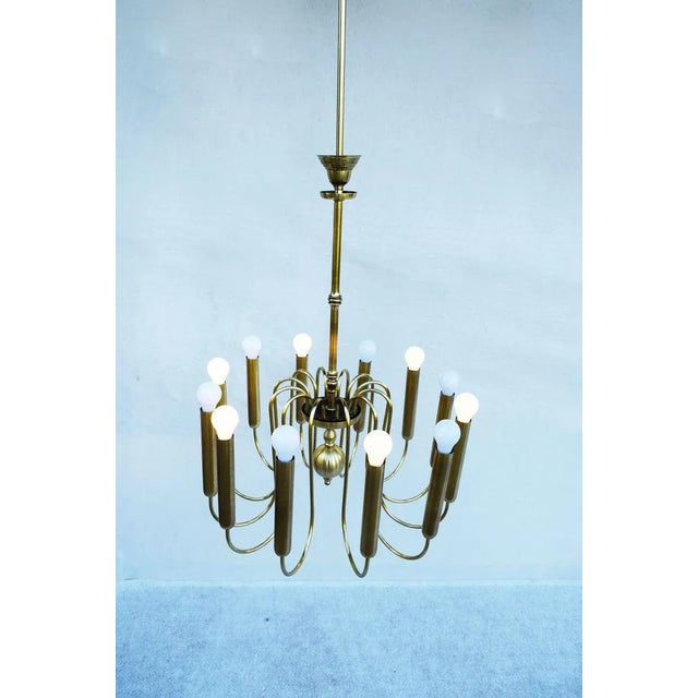Brass ceiling chandelier with 12 lights, made in Italy in the 40's. New and compliant electrical system with dual...