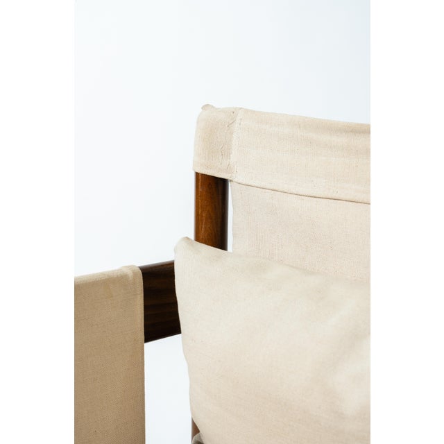 A simple, functional armchair in the scandinavian safari style, embodying the light, nomadic-inspired spirit of swedish...