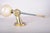 Sculptural wall sconce in the style of Maison Jansen, with a bronze fist gripping a slender torch-like rod. The rod has a...