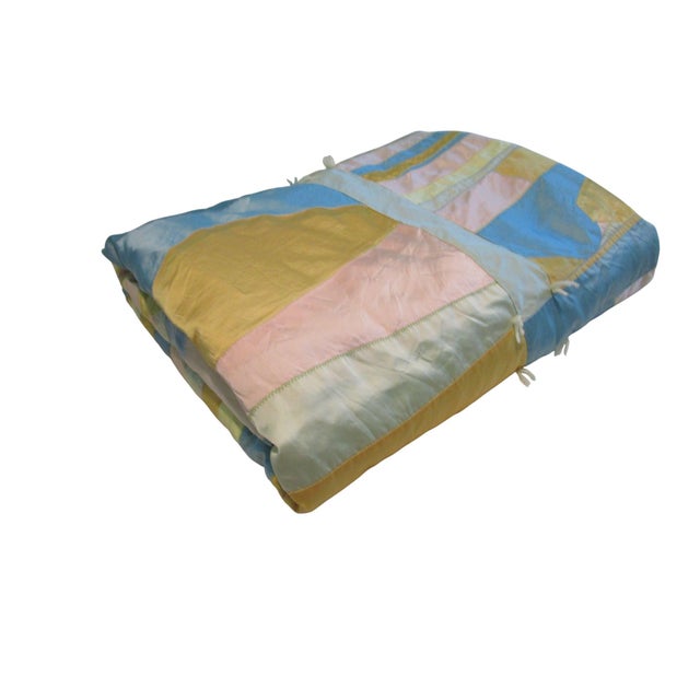 This vintage pastel satin crazy quilt, likely from the 1960s, boasts a pastel patchwork design of 15 blocks. With a...