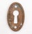 Vintage Classic style oval shaped keyhole cover plate made of brass with an antique brass finish. Made by Yale & Towne....