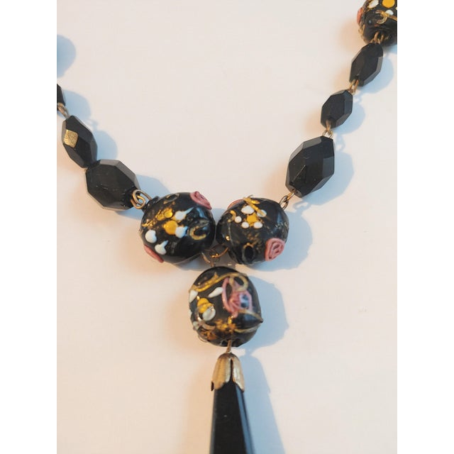 Here's a beautiful late Victorian mourning necklace that features faceted jet beads and wedding cake lampwork beads. It's...