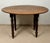 Charming Spanish drop-leaf table crafted from wood, featuring a rounded top and elegant turned legs. The hinged leaves can...