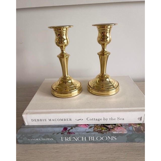 A classic pair of solid brass candlesticks by Baldwin, marked Forged in America. Featuring a timeless turned silhouette...