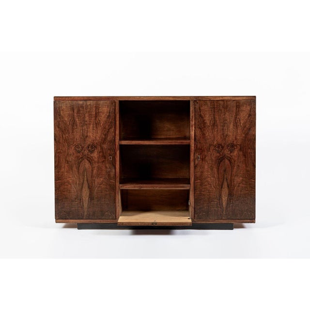 This Italian Art Deco walnut wood sideboard or credenza cabinet is circa 1940. The cabinet features a simple, rectilinear...