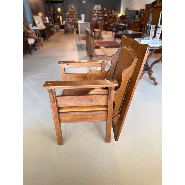Highly unique mission oak chair with a leather seat and brass tacks that converts into a table. Very good antique...
