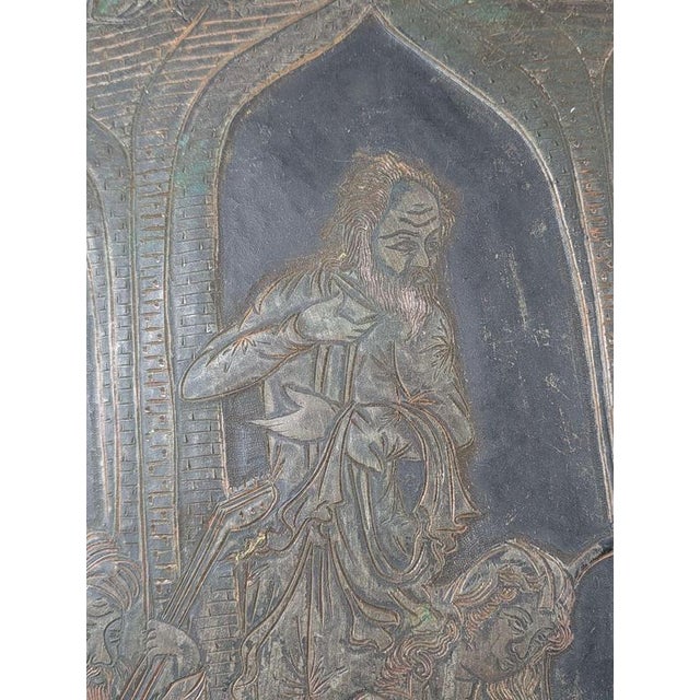 A large and richly decorated Indo-Persian Qajar copper wall charger, dating to the mid-to-late 19th century, worked with...