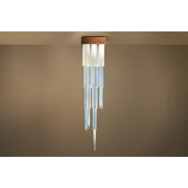 A cascade of opaline glass gives carlo nason’s ls 146 ceiling fixture an unusual sense of movement. Created for mazzega,...