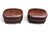 This pair of vintage oval leather ottomans brings warmth and classic character to a living room, library, or study. Rich...