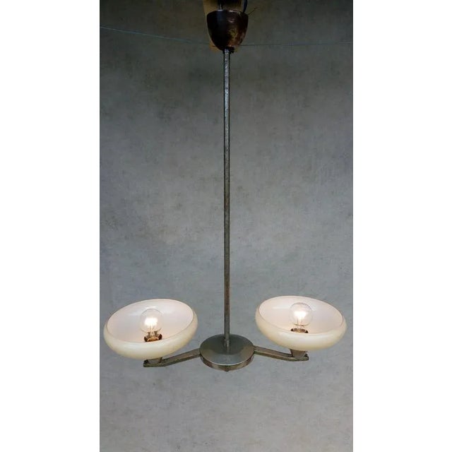 Retro vintage chandelier - lidokov. It has a chrome-plated holder with a distinctive patina. Two light elements of white...