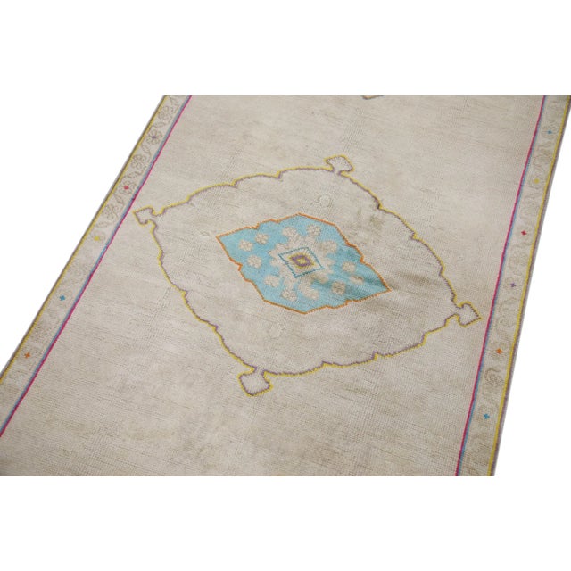 Introducing a one-of-a-kind vintage Turkish hand-knotted wool rug, carefully crafted by skilled artisans using traditional...
