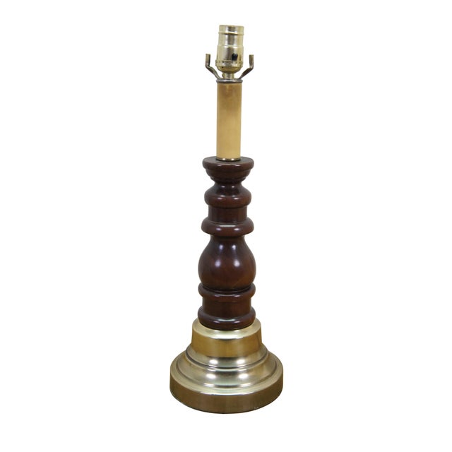 Mid-century table lamp showcasing an elegant combination of classic materials, highlighted by a rich, dark-toned turned...