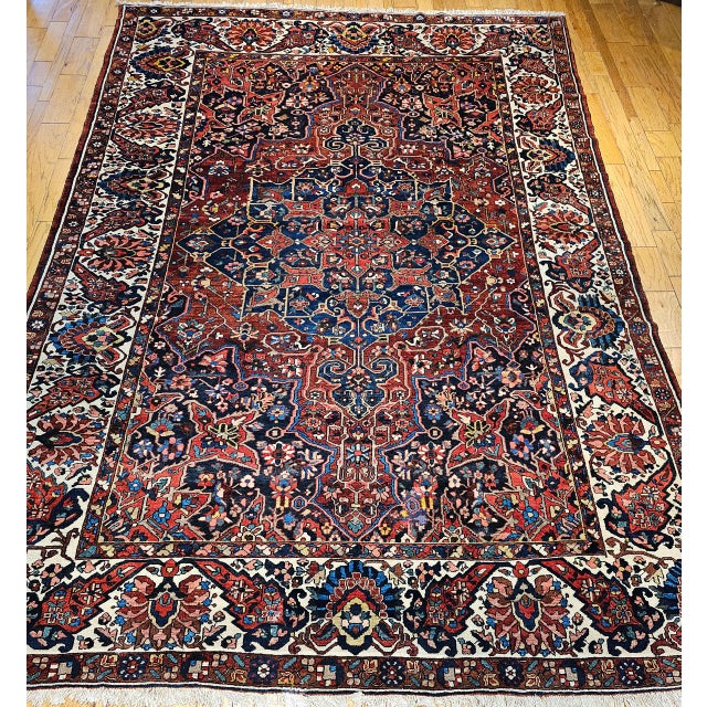 Presenting the Oversize Vintage Persian Bakhtiari rug, hand-knotted circa the mid-1900s. This exceptional carpet features...