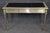 This sophisticated steel, bronze, and leather writing desk, in the style of John Vesey, is an elegant interpretation of...