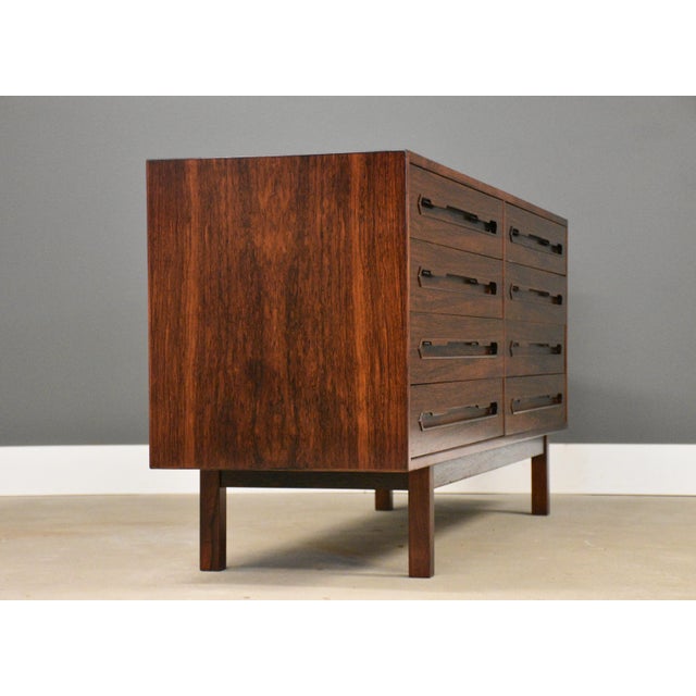 A mid century modern rosewood nine drawer dresser with inset drawer pulls. Professionally refinished. Made in Denmark....