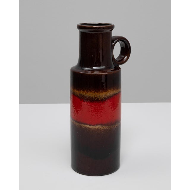 20th Century German W. Germany ceramic vase. This striking mid-century vase exemplifies the bold color palette and...
