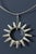 Amazing silver neck ring by Tone Vigeland, with a large stylized pendant in the form of a sun. Vivacious and graphic, a...