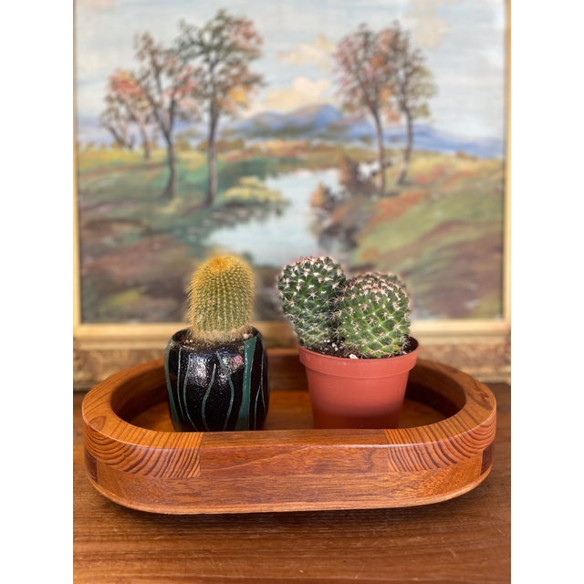 This vintage mid century modern oval tray showcases expert woodworking with laminated joinery and contrasting wood tones...
