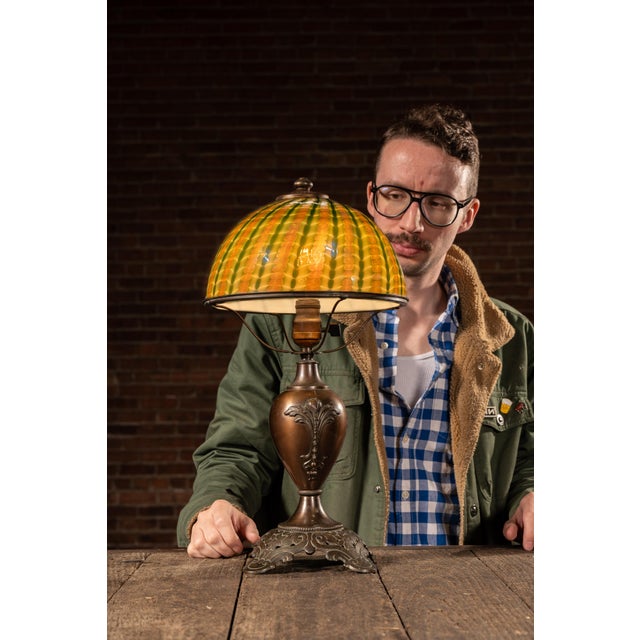 Art Nouveau table lamp by Edward Miller & Co. featuring a bronze-finished cast metal base with floral ornamentation and a...