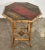 Antique Chinoiserie style bamboo side table featuring beautifully hand-painted design to tabletop and lower accent riser....
