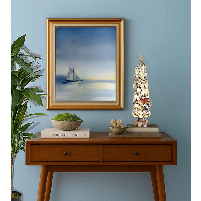 Offering a vintage real seashell topiary with aged silver plate lotus base, circa 1960s. This 18 inch high holiday style...