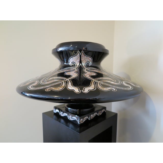 Black lacquer planter with intricate mother of pearl detailing throughout in floral and organic motifs. Indoor use only....