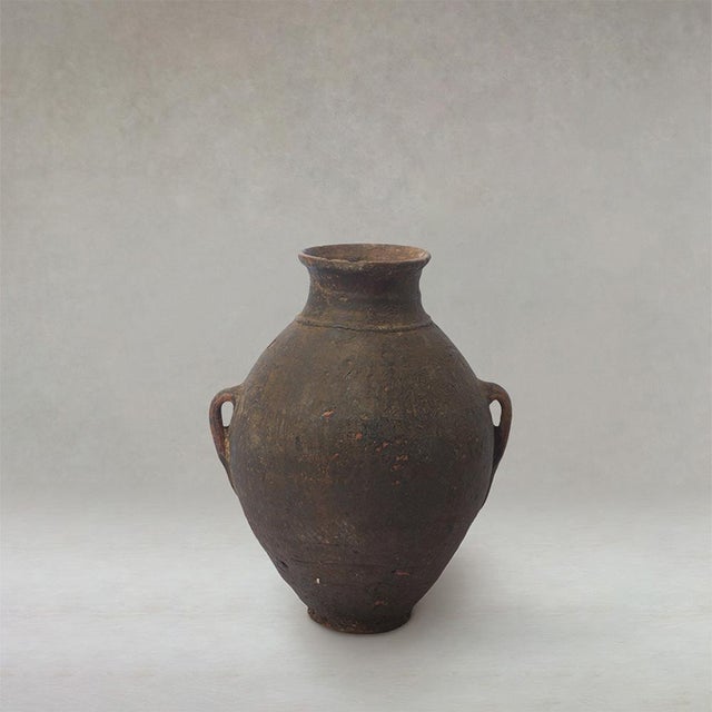 Antique Berber unglazed clay storage jar from Morocco, dating from the early 20th century, with a rounded utilitarian form...