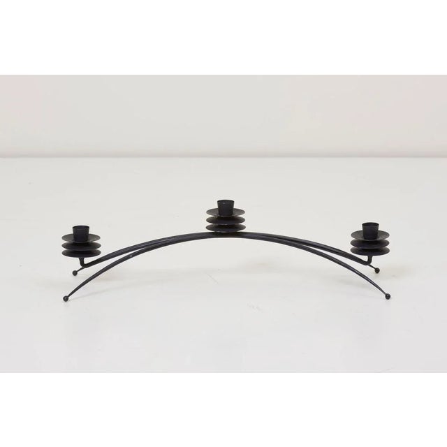 Rare pair of #101 triple candleholder by Tony Paul for Woodlin-Hall in black enameled iron. This piece is attributed to...