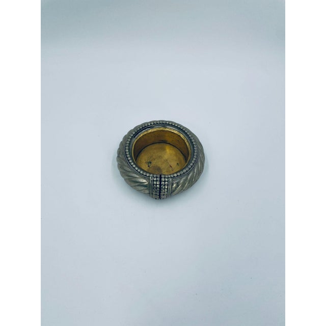 Antique North African and Moroccan bracelet/bowl from 1900-1940, made of tin and brass. This anklet has been handmade into...