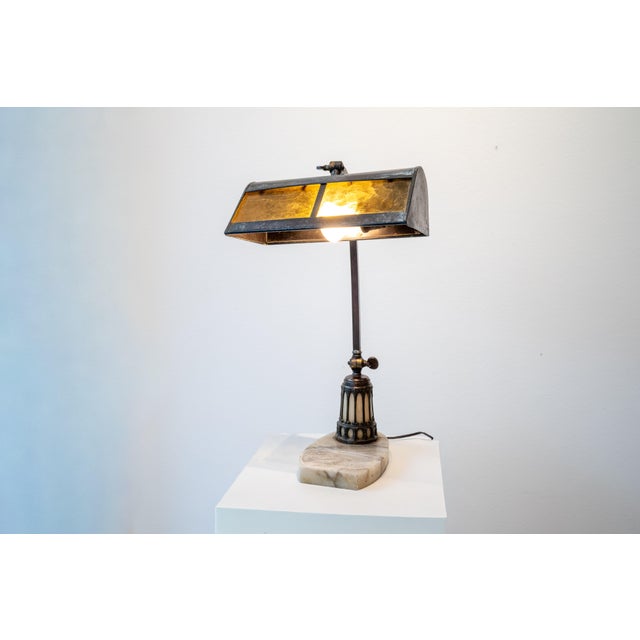 Art Nouveau lamp for a secretary or desk. Made around 1890/1900 This antique lamp shines with a very warm, amber-colored...