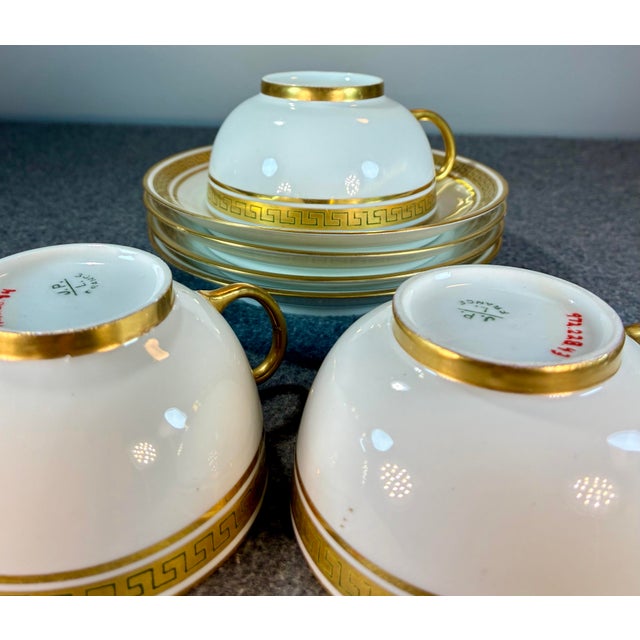 7pc-J.P.Limoges set consisting of 2 cups and 3 saucers. White French porcelain trimmed in black & gold Greek key design....