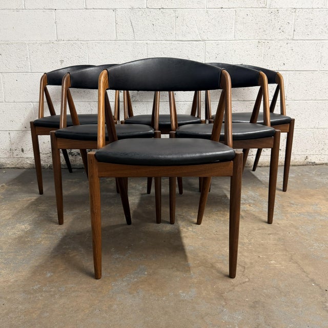 A set of six Model 31 dining chairs designed by Kai Kristiansen for Schou Andersen Møbelfabrik in Denmark. The design is...