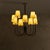 A mid-20th century French chandelier, wrought in blackened iron with ten sweeping arms that curve outward in perfect...