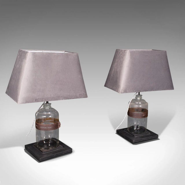 This is a pair of antique jar lamps. An English, paraffin glass jar with slate base side light, dating to the Victorian...
