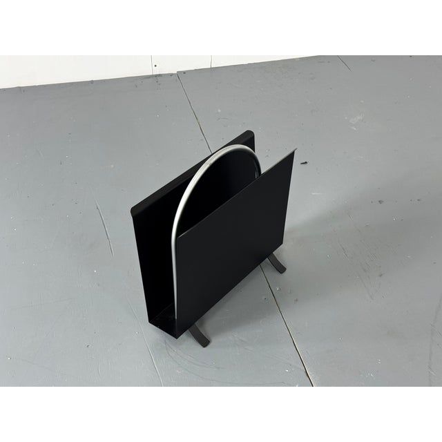 A lovely black and silver metal magazine rack after the 1930s design by W.H.Gispen. The round, tubular steel handle is a...