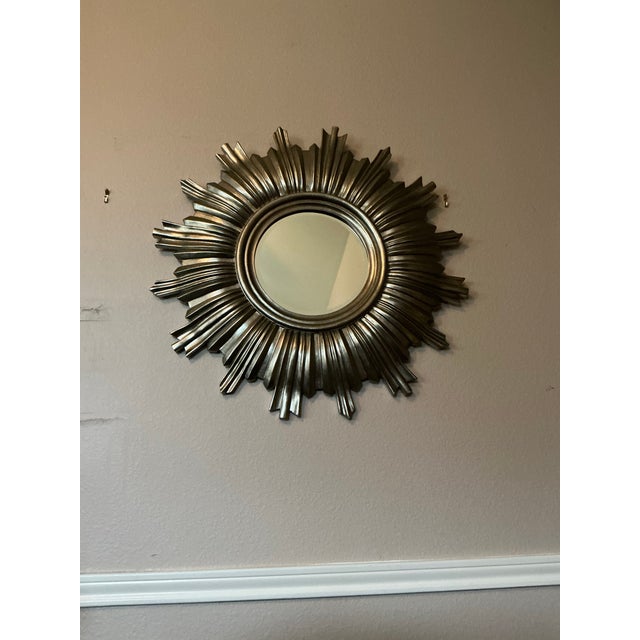 This striking vintage sunburst wall mirror adds instant drama and sculptural presence to any room. The circular center...