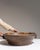 This early 20th century serving bowl from France is finished in chocolate, worked in ceramic. Its form follows honest,...