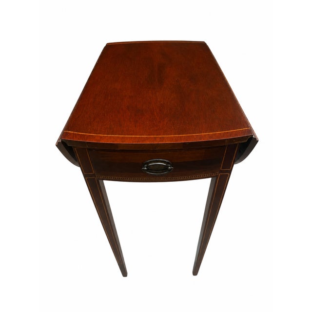 Elegant vintage Mersman drop-leaf accent table crafted in the Federal tradition, featuring a rich mahogany-toned finish,...