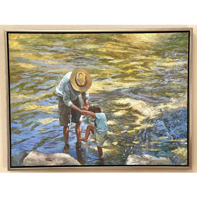 This oil on canvas piece captures a tender moment between an adult and a child wading through a shimmering stream, their...