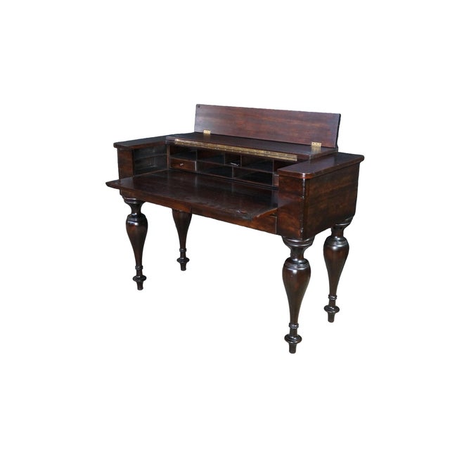 This exceptional antique mahogany spinet desk features a classic conversion-style design, showcasing a rich, deep reddish-...