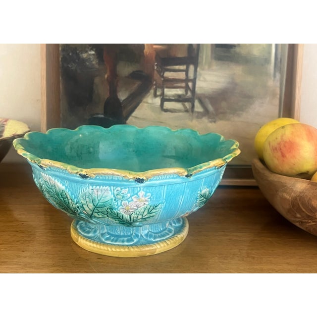 Antique majolica bowl made in the late 19th century. The bowl which has a turquoise glaze inside has a yellow scalloped...