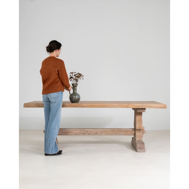 A robust French oak dining table crafted in the trestle tradition, known for its sturdy construction and timeless appeal....