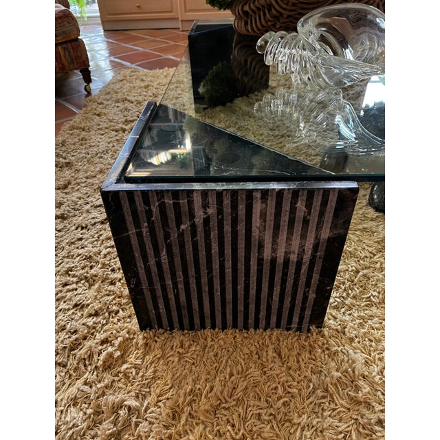 Four fluted edge marble triangles serve as base for this large coffee/cocktail table. The black marble has white veining...