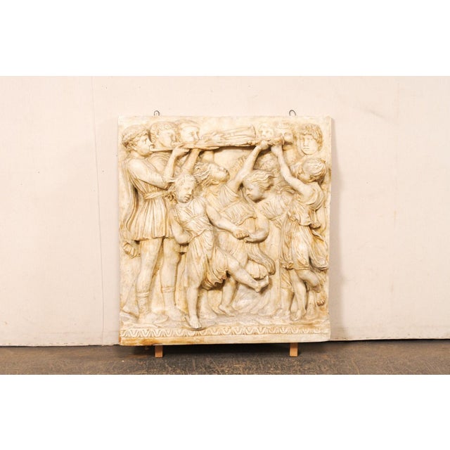An Italian plaster wall sculpture relief plaque, in youth Roman figures theme, from the mid-20th century. This vintage art...