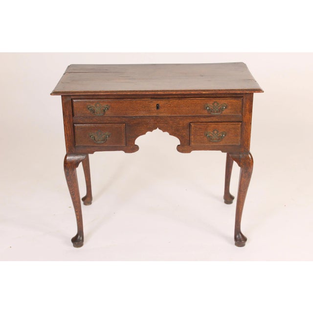 Antique Queen Ann style oak lowboy, 18th century. With cabriole legs ending in pad feet. and nice old color.
