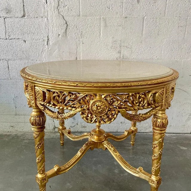 This center table is the perfect piece to add glitz, glam and luxury to an entryway. The gold finish on this piece is...