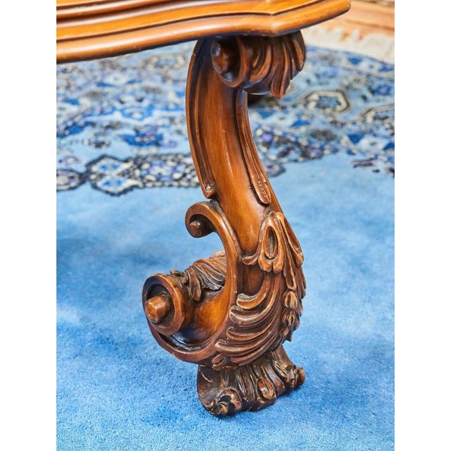 Baroque style coffee table with rich carvings. An elegant piece of furniture made of solid wood with precisely shaped...