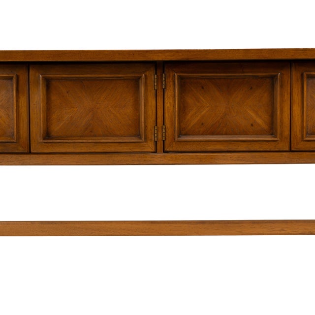 Beautiful vintage Drexel walnut credenza featuring a striking architectural design with recessed geometric panel doors,...